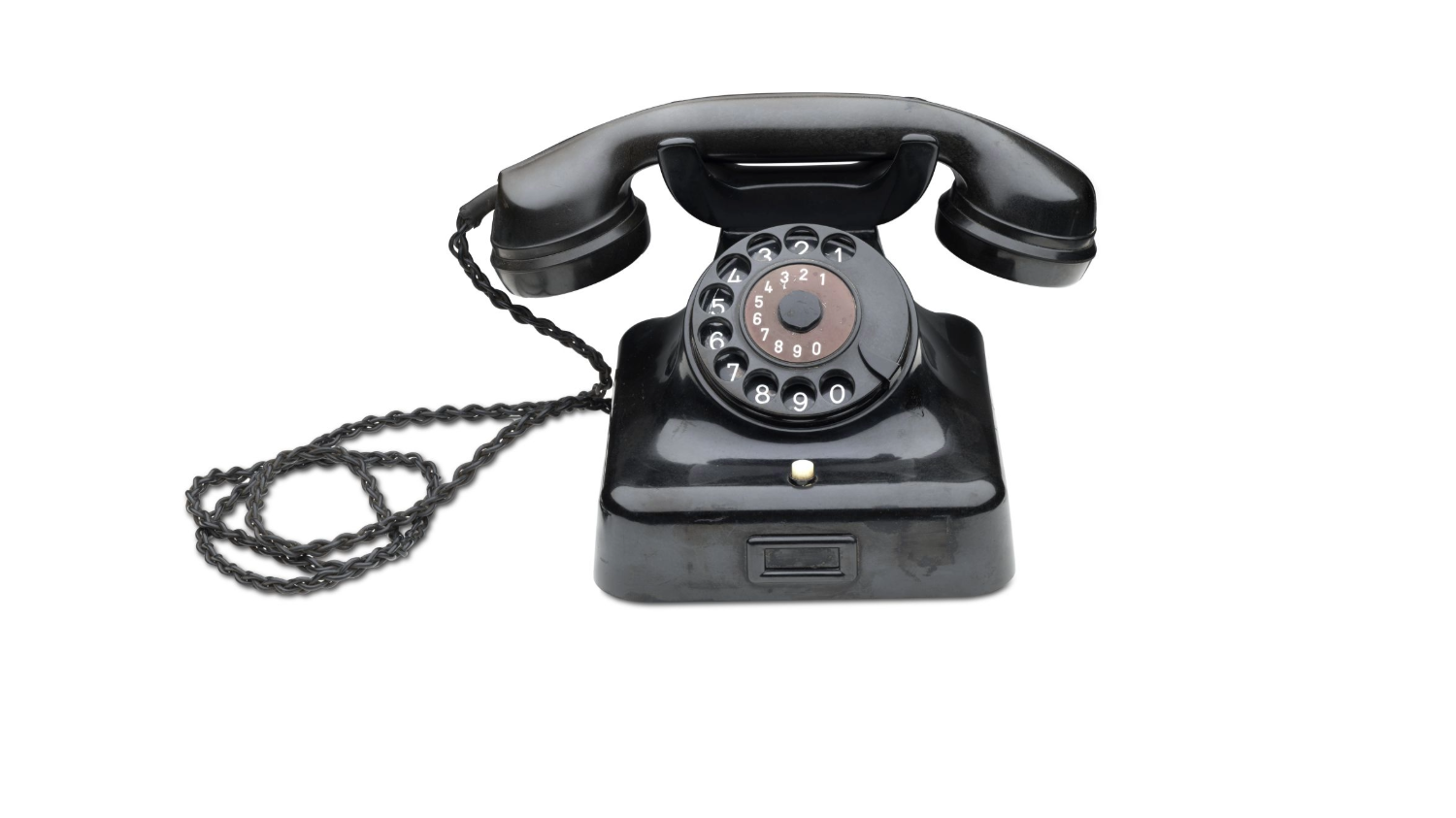 Black telephone with a handset resting on the telephone cord, a dialling disc and a twisted cable